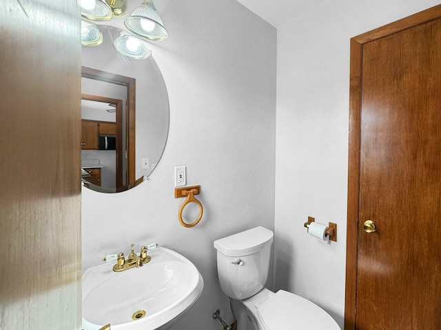 bathroom featuring toilet and a sink