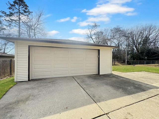 detached garage featuring fence