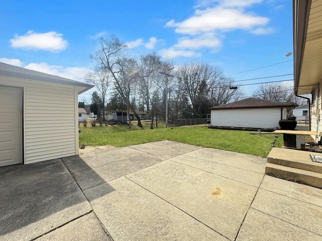 view of patio / terrace with an outdoor structure and fence