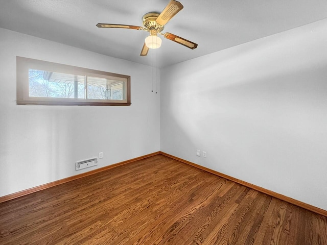 unfurnished room with visible vents, ceiling fan, baseboards, and wood finished floors