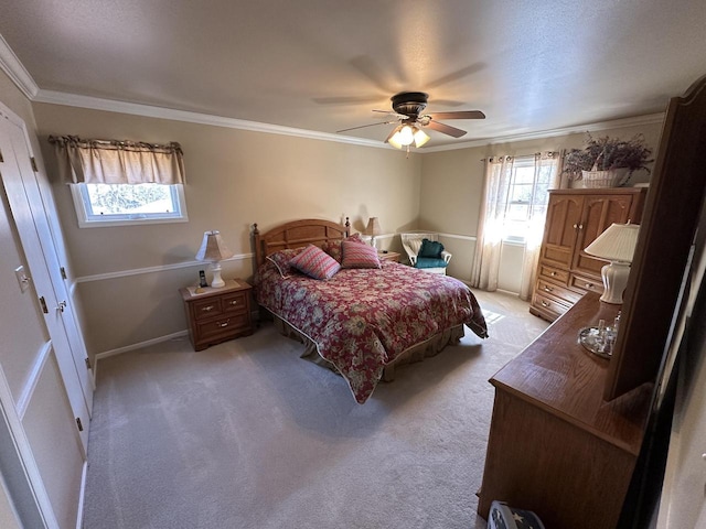 bedroom featuring light colored carpet, ornamental molding, and a ceiling fan