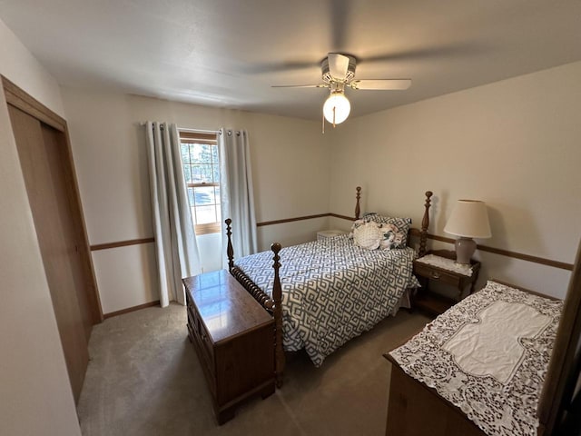 carpeted bedroom featuring a closet, baseboards, and ceiling fan