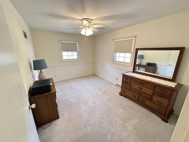 bedroom featuring visible vents, light colored carpet, baseboards, and ceiling fan