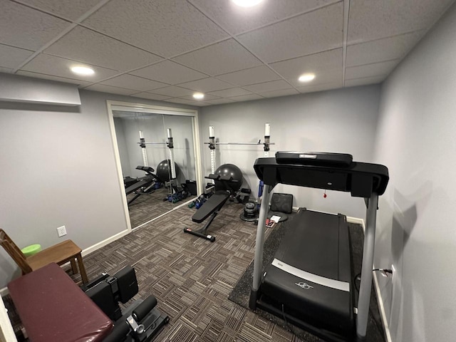 exercise room with recessed lighting, baseboards, a paneled ceiling, and carpet