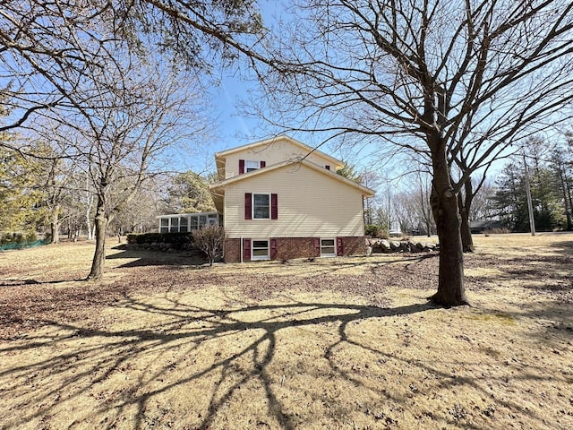 view of side of property with a sunroom