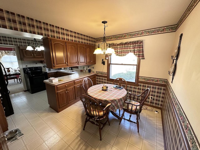 dining space featuring wallpapered walls and light floors