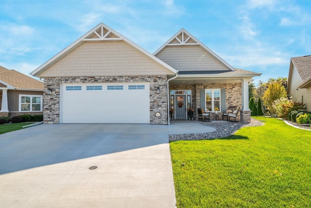 craftsman-style house featuring stone siding, a garage, driveway, and a front lawn