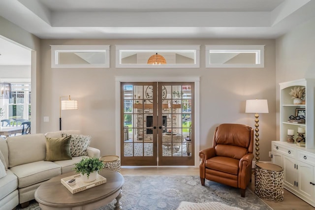 living room with french doors and light wood-style floors