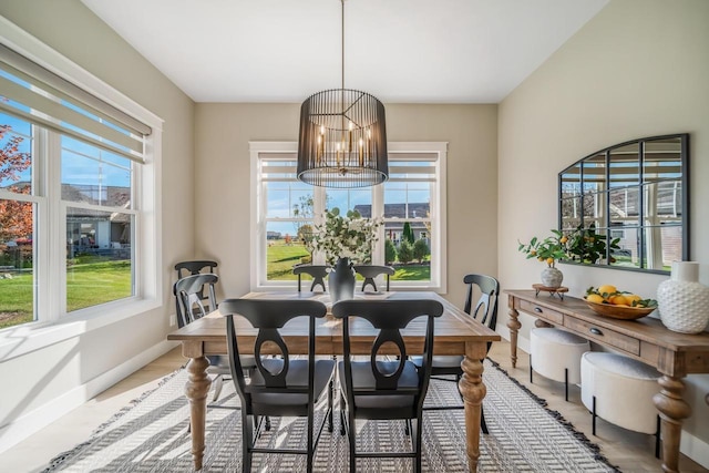 dining area with a notable chandelier and baseboards