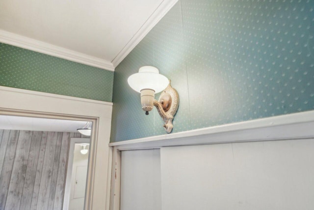 room details with wallpapered walls and ornamental molding