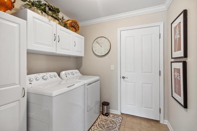 clothes washing area featuring light tile patterned floors, baseboards, cabinet space, crown molding, and washer and clothes dryer