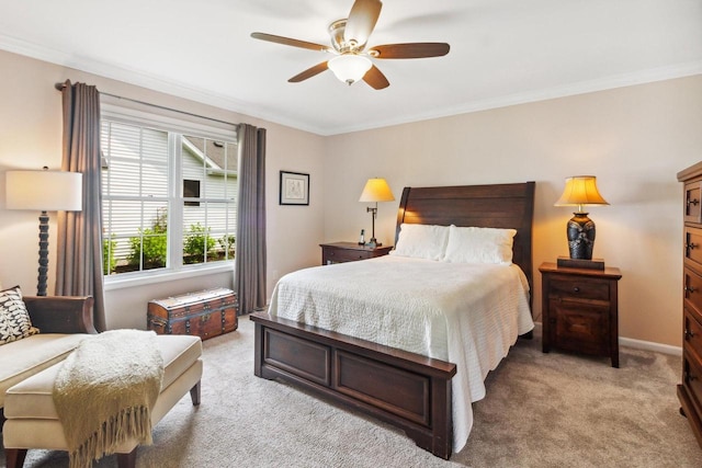 bedroom featuring light colored carpet, a ceiling fan, baseboards, and ornamental molding