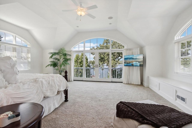 carpeted bedroom featuring visible vents, access to exterior, a decorative wall, ceiling fan, and vaulted ceiling