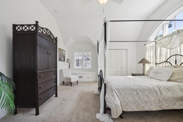 carpeted bedroom with a closet and vaulted ceiling