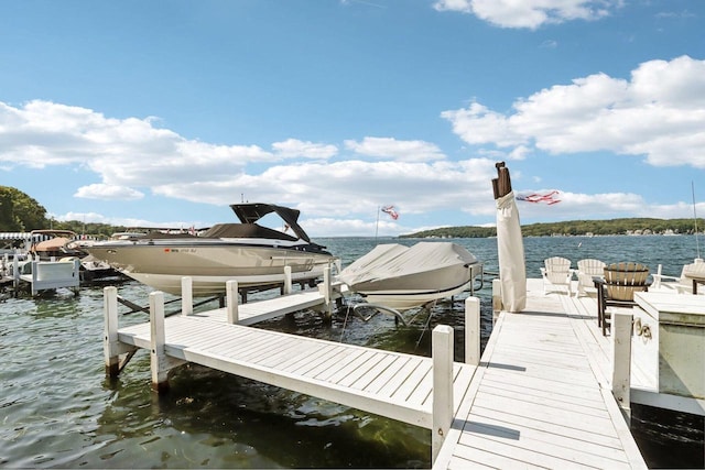 dock area with a water view and boat lift