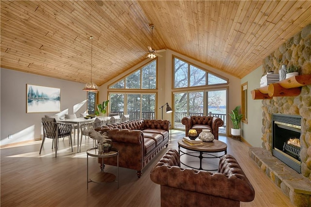 living room with wooden ceiling, wood finished floors, a wealth of natural light, and high vaulted ceiling