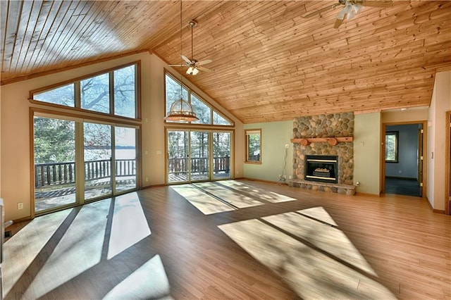 unfurnished living room with wood finished floors, high vaulted ceiling, ceiling fan, and a fireplace