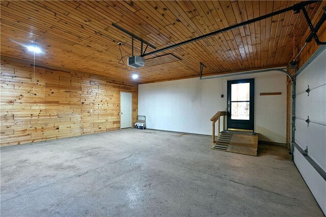 garage featuring wooden walls, wood ceiling, and a garage door opener