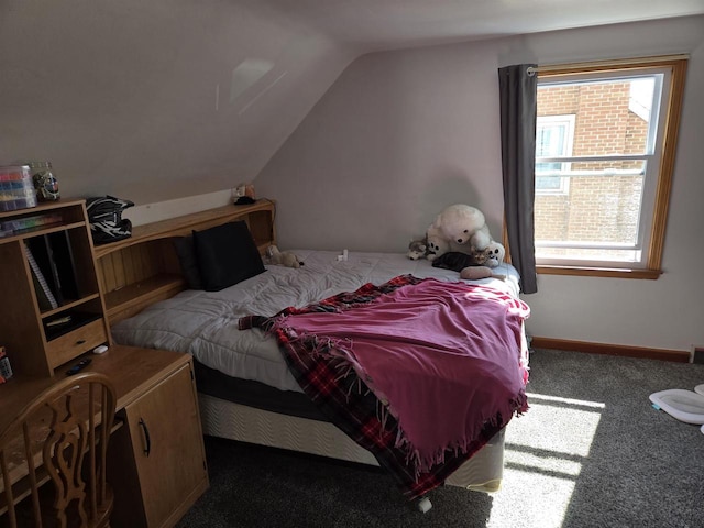 bedroom featuring baseboards, carpet flooring, and vaulted ceiling