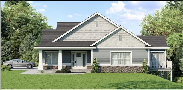 craftsman house featuring a front yard, covered porch, and stone siding