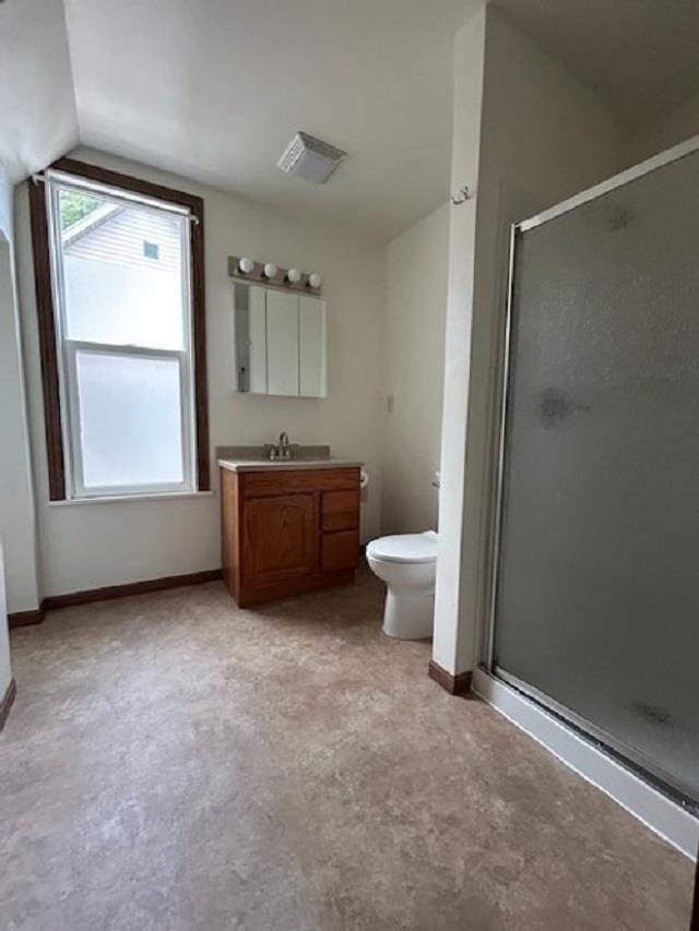 bathroom with visible vents, a stall shower, vanity, and vaulted ceiling