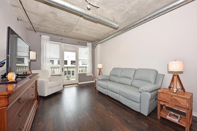 living room with baseboards and dark wood-style flooring