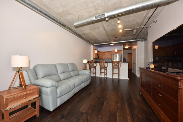 living room featuring visible vents and dark wood-style floors