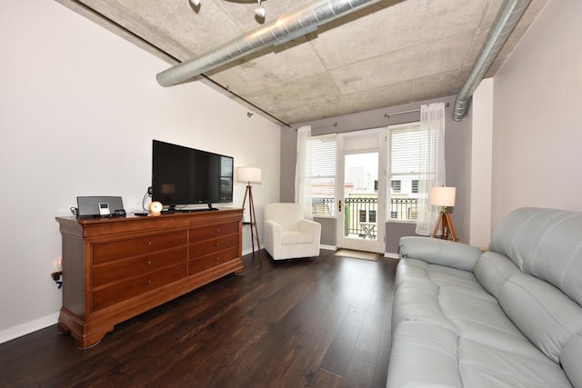 living area featuring baseboards and wood finished floors