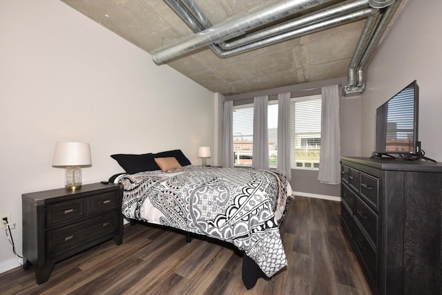 bedroom with baseboards and dark wood-style floors