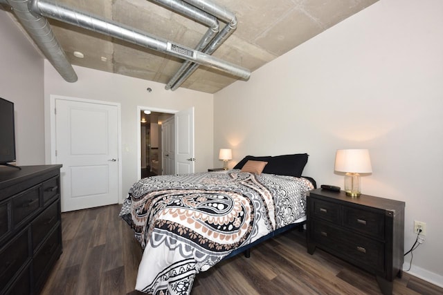 bedroom featuring visible vents and dark wood-style floors