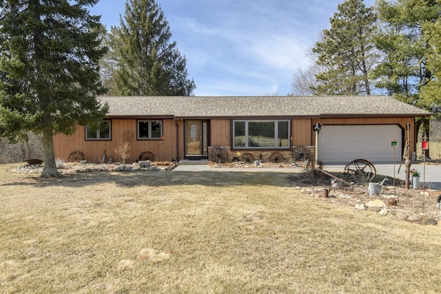 ranch-style house featuring a garage, driveway, a front lawn, and a shingled roof