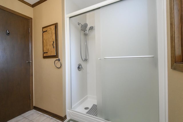 full bathroom with tile patterned flooring and a shower stall