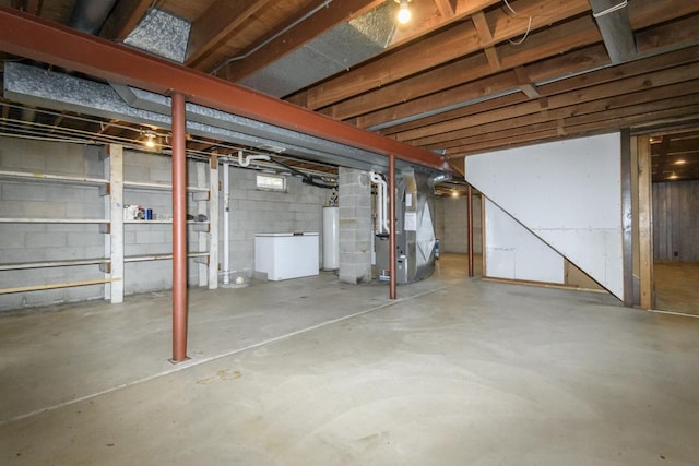 unfinished basement with heating unit and water heater