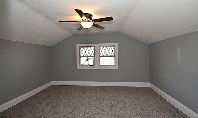 additional living space with vaulted ceiling, a ceiling fan, baseboards, and carpet floors