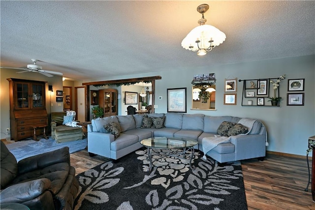 living area with wood finished floors, baseboards, and a textured ceiling