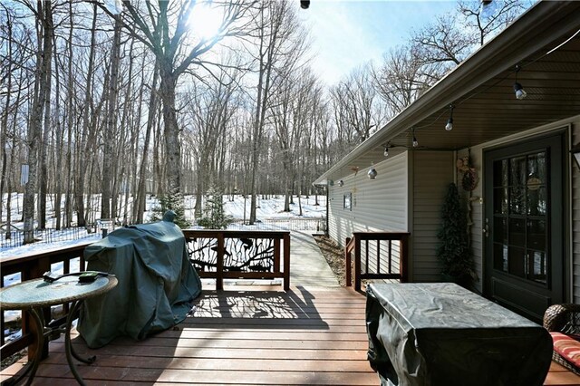 snow covered deck featuring grilling area