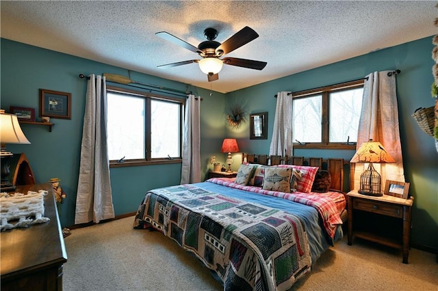 bedroom featuring baseboards, a textured ceiling, ceiling fan, and carpet floors