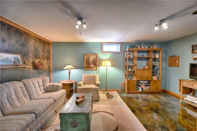 living area with wooden walls, baseboards, and concrete floors