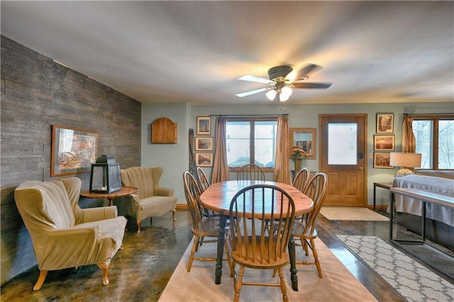 dining space featuring plenty of natural light, a textured ceiling, concrete floors, and a ceiling fan