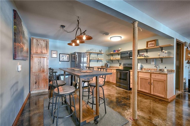 kitchen featuring open shelves, concrete floors, appliances with stainless steel finishes, and a sink