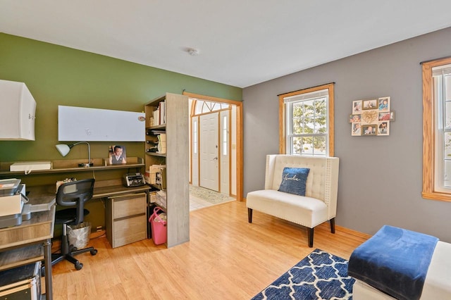 home office with light wood finished floors