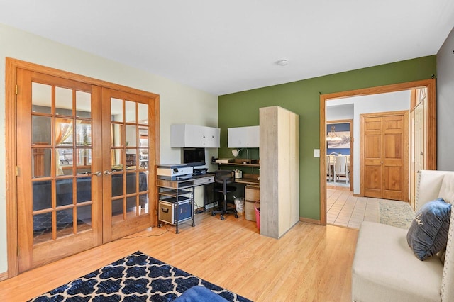 office with wood finished floors, french doors, and baseboards