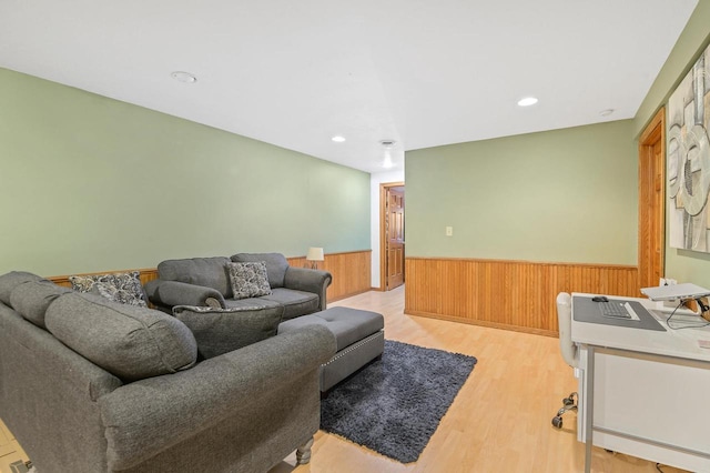 living area featuring recessed lighting, a wainscoted wall, wood walls, and light wood finished floors