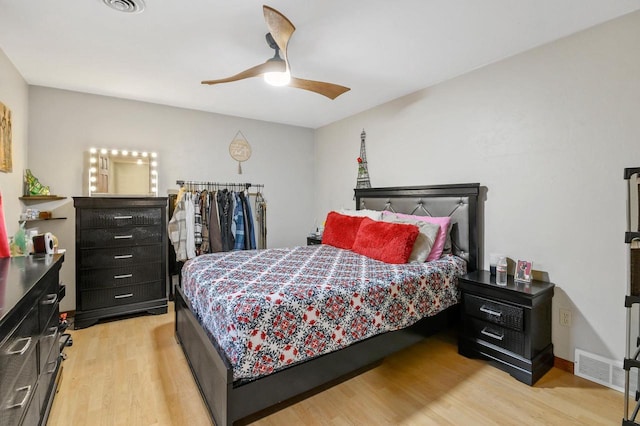 bedroom featuring visible vents, a ceiling fan, and light wood-style floors