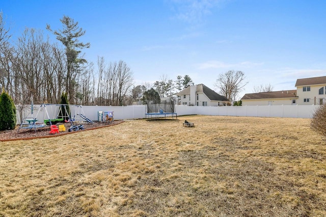 view of yard with a fenced backyard and a trampoline