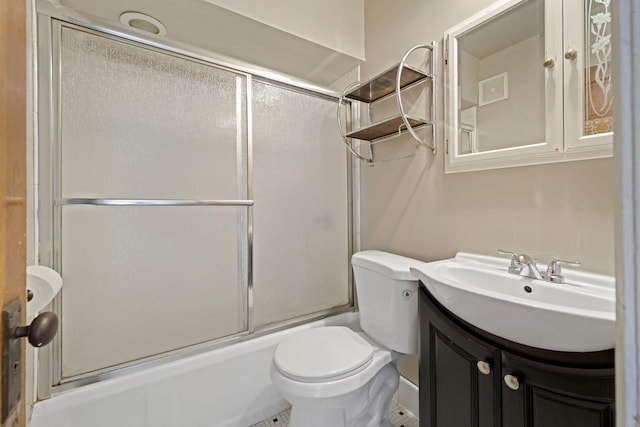 bathroom featuring enclosed tub / shower combo, toilet, and vanity