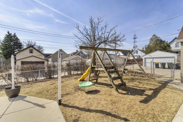 view of playground with a residential view, an outdoor structure, and fence