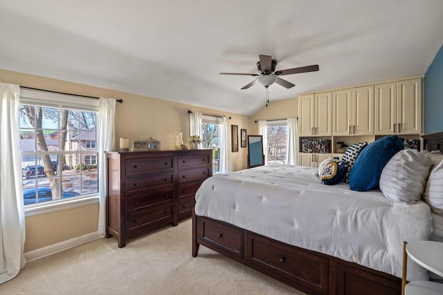 bedroom with baseboards, light carpet, lofted ceiling, and a ceiling fan