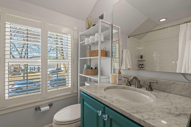 bathroom featuring toilet, curtained shower, and vanity