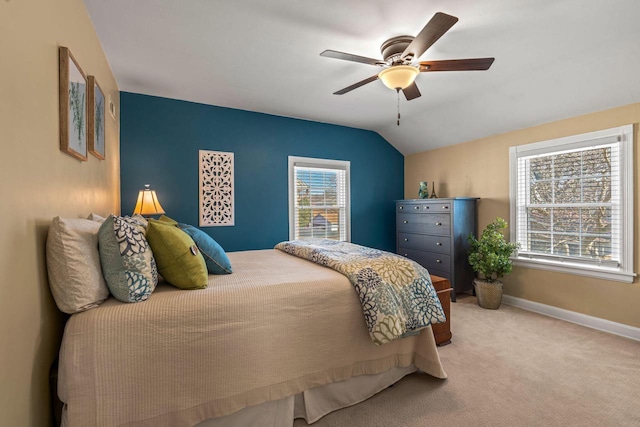 carpeted bedroom featuring baseboards, lofted ceiling, and a ceiling fan